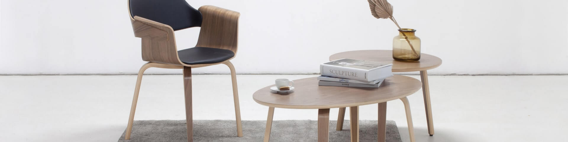 Plydesign's SUBMARINE Nesting Coffee Table: Sleek, minimalistic design with warm wood accents for cozy relaxation.